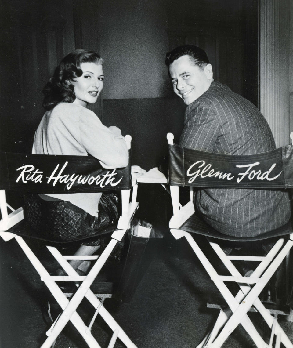 Rita Hayworth sits next to actor Glenn Ford on the set of Gilda (Courtesy Running Press)