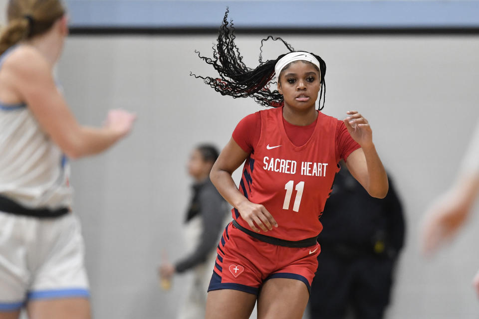 Sacred Heart Academy guard ZaKiyah Johnson plays during a high school basketball game against Mercy Academy in Louisville, Ky., Sunday, Feb. 11, 2024. The junior wing ranked as a top-five overall prospect for next season has pared her list down to a dozen schools, an elite group that includes defending national champion LSU, current No. 1 and two-time champ South Carolina and of course, nearby Louisville. (AP Photo/Timothy D. Easley)