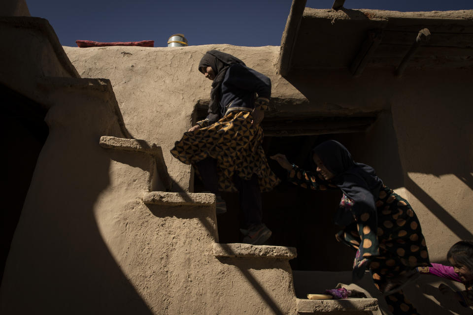 Mina Ahmed's children play in their house at Salar village, Wardak province, Afghanistan, Sunday, Oct. 24, 2021.In urban centers, public discontent toward the Taliban is focused on threats to personal freedoms, including the rights of women. In Salar, these barely resonate. The ideological gap between the Taliban leadership and the rural conservative community is not wide. Many villagers supported the insurgency and celebrated the Aug. 15 fall of Kabul which consolidated Taliban control across the country. (AP Photo/Oriane Zerah)