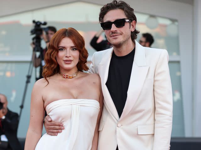<p>Alessandra Benedetti - Corbis/Corbis/Getty</p> Bella Thorne and Mark Emms attend a red carpet for the movie "Priscilla" at the 80th Venice International Film Festival on September 04, 2023 in Venice, Italy.