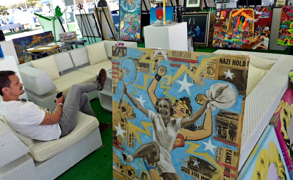 Jozef Batko with Jorge Blanco Originals and Limited Editions, Andrew Ford Fine Art, awaits potential buyers for the many artworks that are on display during Sarasota's Elizabeth Moore Sarasota Open ATP Challenger tennis tournament.