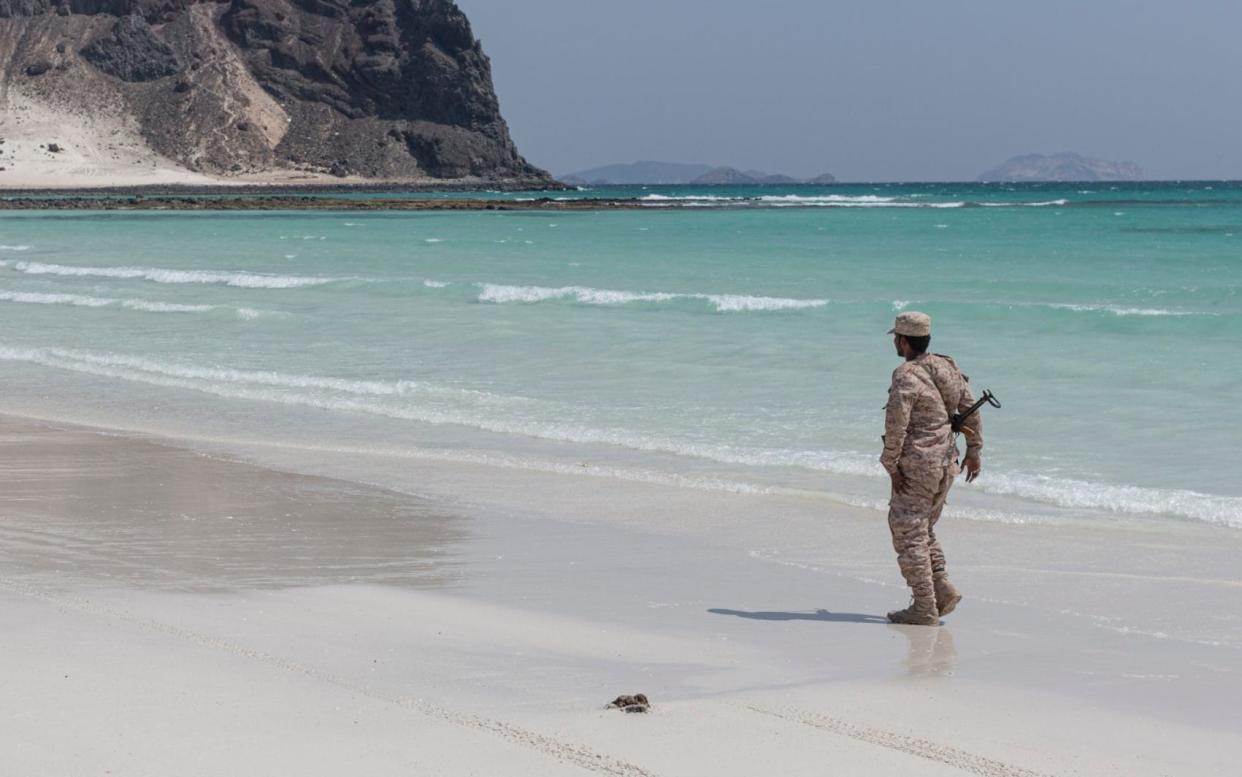 A Yemeni soldier walks along the beach at Bin Ali, near the Balhaf Natural Gas facility and Emirati military base - Sam Tarling / The Sana'a Centre