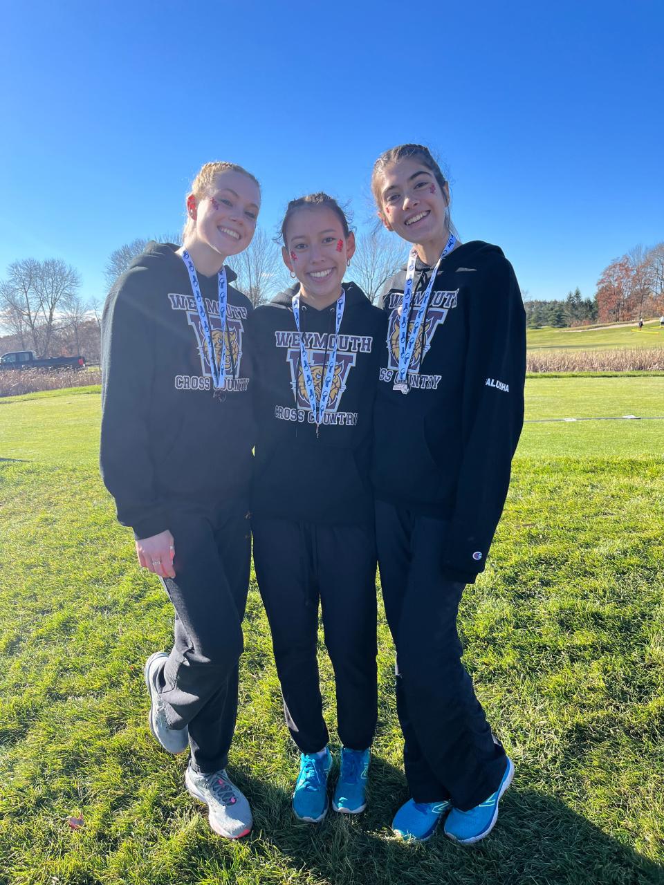 From left to right, Gracie Richard, Kate Carnes and Izzy Galusha helped the Weymouth High girls cross country team place second overall in the Div. 1A race at Gardner Golf Course.