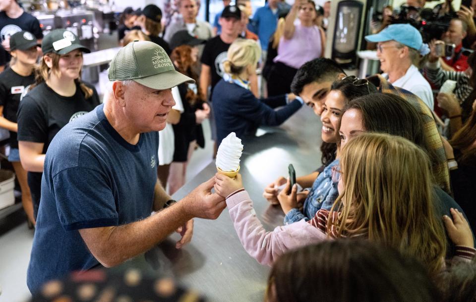 Democratic vice presidential nominee Minnesota Gov. Tim Walz serves ice cream to visitors at the Dairy Barn in the Minnesota State Fair on September 1, 2024 (Getty Images)