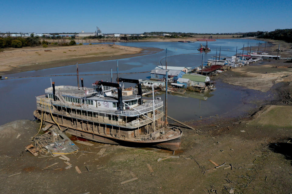 a boat in the mud of a dried up river