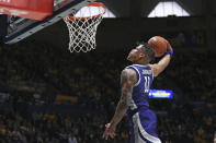Kansas State forward Keyontae Johnson (11) soars to the basket against West Virginia during the first half of an NCAA college basketball game on Saturday, March 4, 2023, in Morgantown, W.Va. (AP Photo/Kathleen Batten)