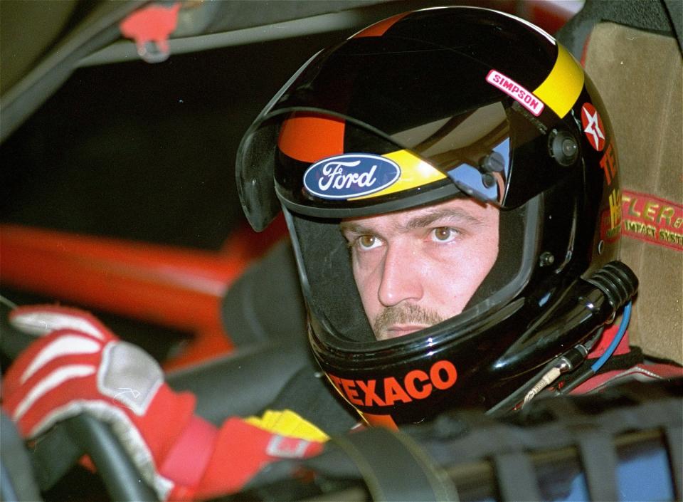 FILE - In this Nov. 13, 1992, file photo, driver Davey Allison sits in his car as it is checked after a practice run for the NASCAR auto race at Atlanta Motor Speedway in Hampton, Ga. Allison is being inducted into the NASCAR Hall of Fame on Friday, Feb. 1, 2019. (AP Photo/Curtis Compton, File)