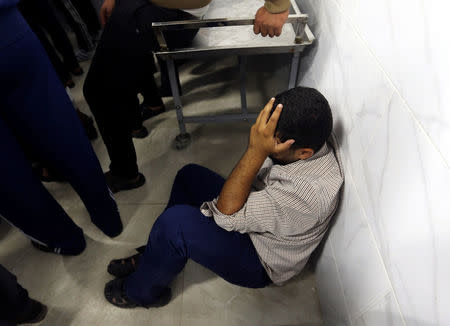 A Palestinian man reacts at a hospital after his relative was killed near the border between Israel and central Gaza Strip October 30, 2017. REUTERS/Ibraheem Abu Mustafa