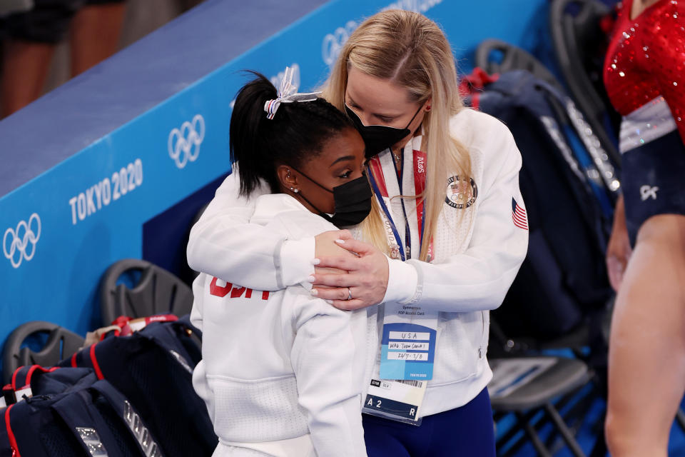 TOKYO, JAPAN - JULY 27: Simone Biles of Team United States is embraced by coach Cecile Landi during the Women's Team Final on day four of the Tokyo 2020 Olympic Games at Ariake Gymnastics Centre on July 27, 2021 in Tokyo, Japan. (Photo by Jamie Squire/Getty Images)