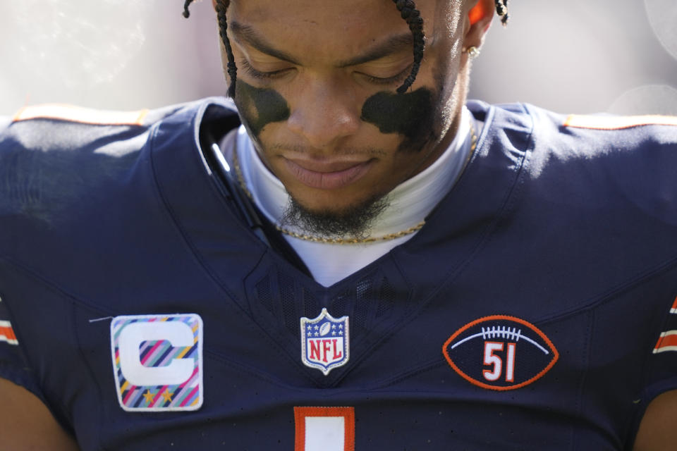 Chicago Bears quarterback Justin Fields walks to the locker room injured during the second half of an NFL football game against the Minnesota Vikings, Sunday, Oct. 15, 2023, in Chicago. On Field's jersey is the football and No. 51 patch honoring Dick Butkus. Fields never returned to the game. (AP Photo/Charles Rex Arbogast)