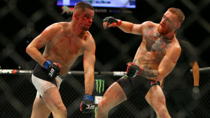 Nate Diaz lands a punch on Conor McGregor during their UFC 196 fight. (Getty)