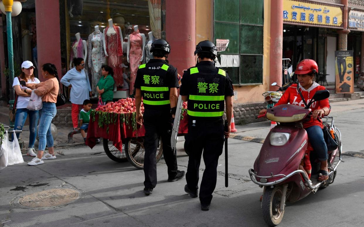 Police officers patrolling in Kashgar, in China's western Xinjiang region, where authorities have persecuted the mainly Muslim Uighurs. - AFP