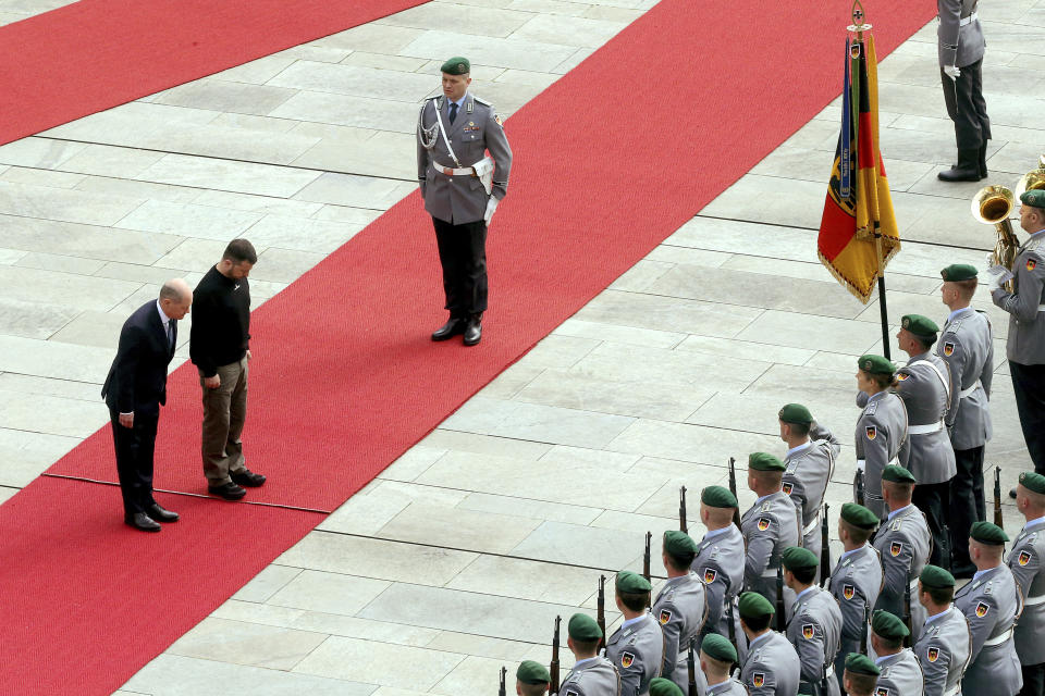 FILE - Ukrainian President Volodymyr Zelenskyy, center, and German Chancellor Olaf Scholz, left, review the honor guard at the Federal Chancellery in Berlin, Sunday, May 14, 2023. While the world awaits Ukraine's spring offensive, its leader Volodymyr Zelenskyy has already launched a diplomatic one. In a span of a week, he has dashed to Italy, the Vatican, Germany, France and Britain to shore up support for the defense of his country. On Friday, May 19, 2023, he was in Saudi Arabia to meet with Arab leaders, some of whom are allies with Moscow. (Wolfgang Kumm/dpa via AP, File)