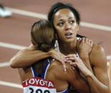 Katarina Johnson-Thompson of Britain (R) hugs compatriot Jessica Ennis-Hill of Britain after their 200 metres event of the women's heptathlon at the 15th IAAF World Championships at the National Stadium in Beijing, China August 22, 2015. REUTERS/David Gray