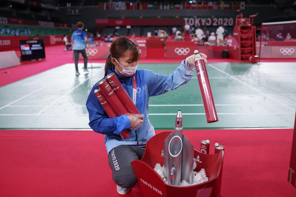 <p>A volunteer cleans and disinfects the court during badminton competition on day one of the Tokyo 2020 Olympic Games at Musashino Forest Sport Plaza on July 24, 2021 in Chofu, Tokyo, Japan. (Photo by Lintao Zhang/Getty Images)</p> 
