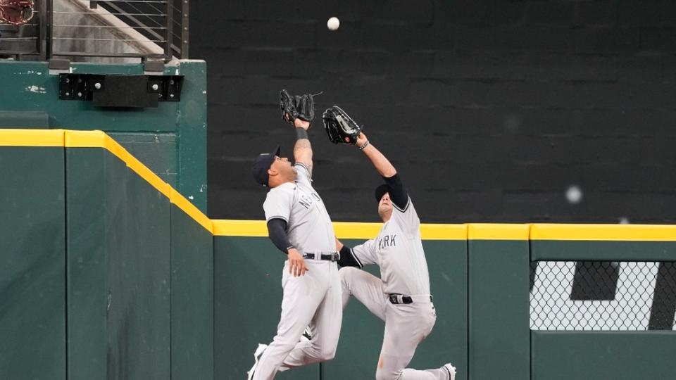 New York Yankees left fielder Aaron Hicks (31) catches a fly-out in front of center fielder Isiah Kiner-Falefa (12) on a ball hit by Texas Rangers first baseman Nathaniel Lowe.