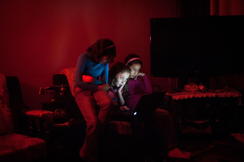<p>Yara and her friends prepare a dance number during a blackout. Fuel is scarce in Gaza and many families only receive six to eight hours of electricity a day. (Photograph by Monique Jaques) </p>