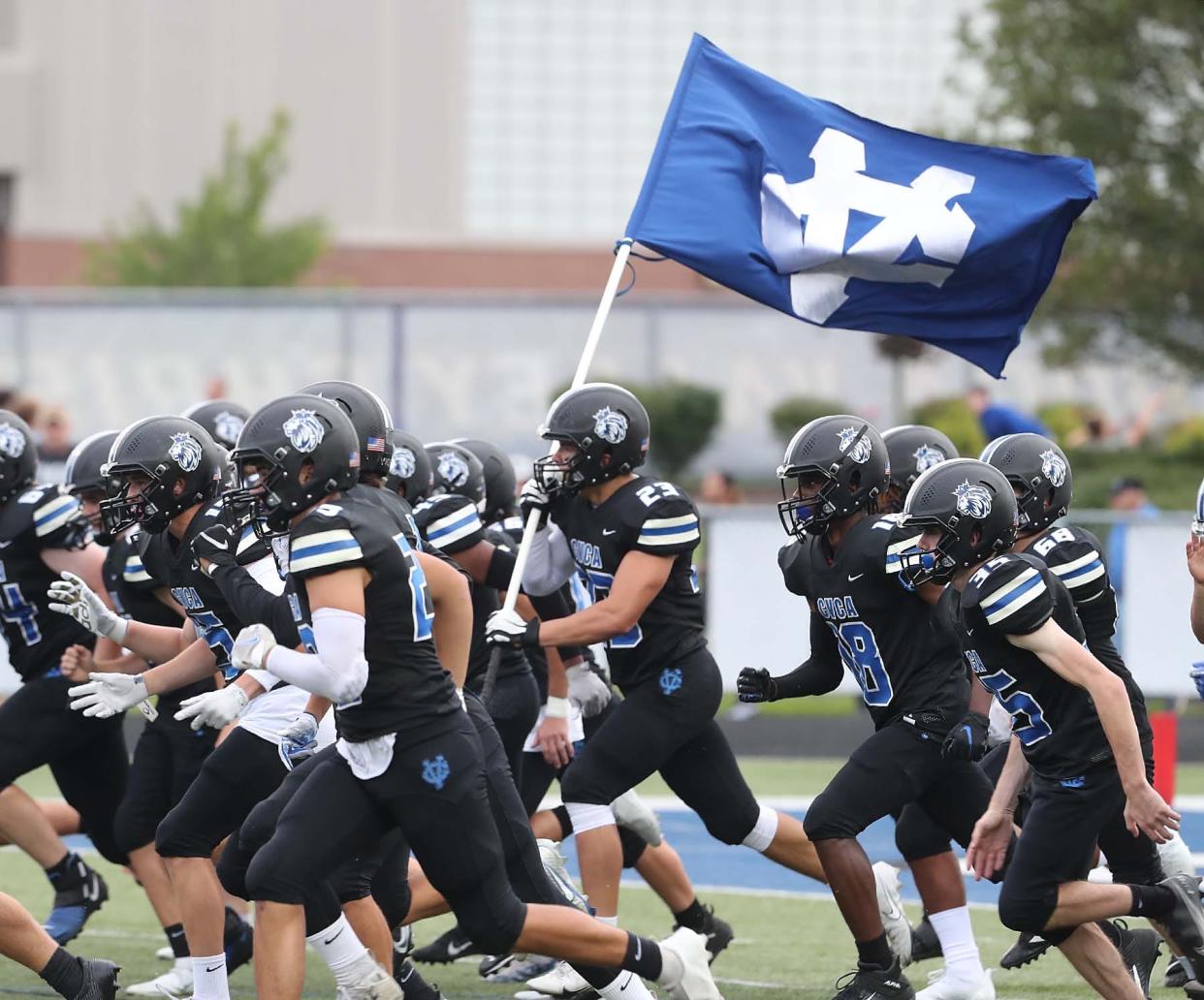 The CVCA football team takes to the field before their game against Woodridge at CVCA Friday, Sept. 3, 2021 in Cuyahoga Falls, Ohio.