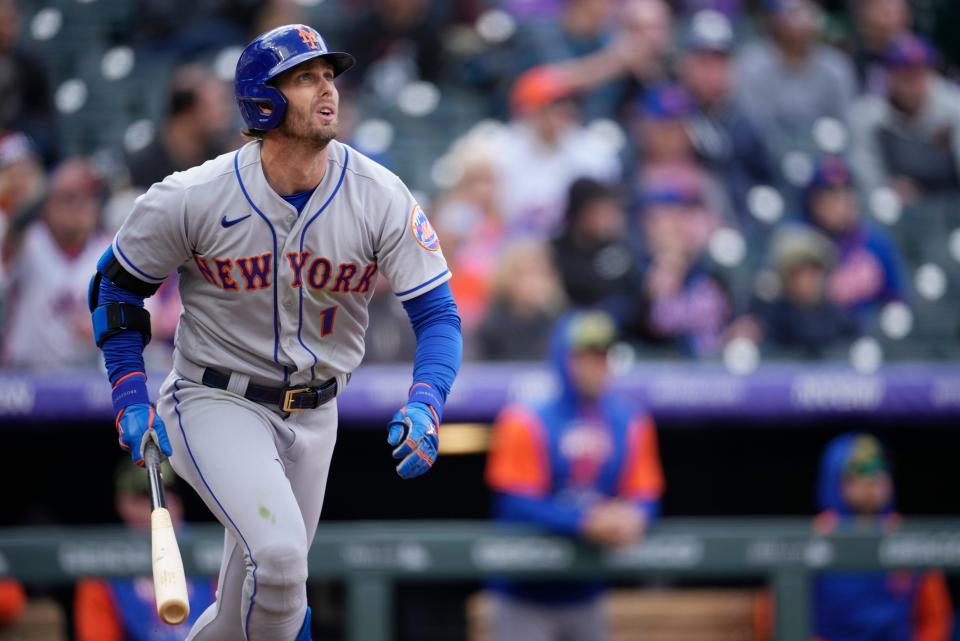 New York Mets' Jeff McNeil follows the flight of his double off Colorado Rockies starting pitcher German Marquez in the fifth inning of the first baseball game game of a day/night doubleheader Saturday, May 21 2022, in Denver.