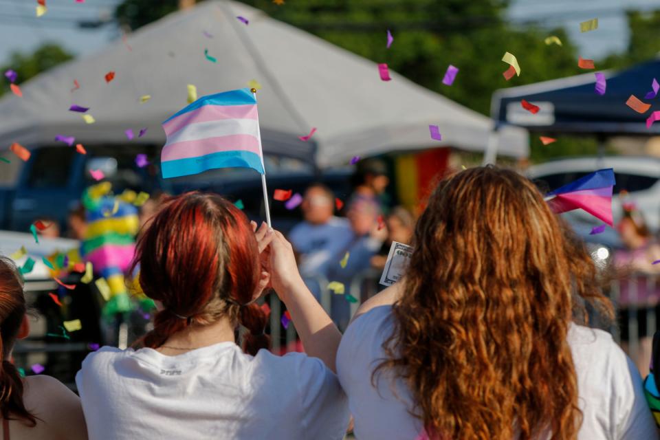 Crowd members wave a transgender flag at the Pride Parade in Oklahoma City, Okla., on June 5.
