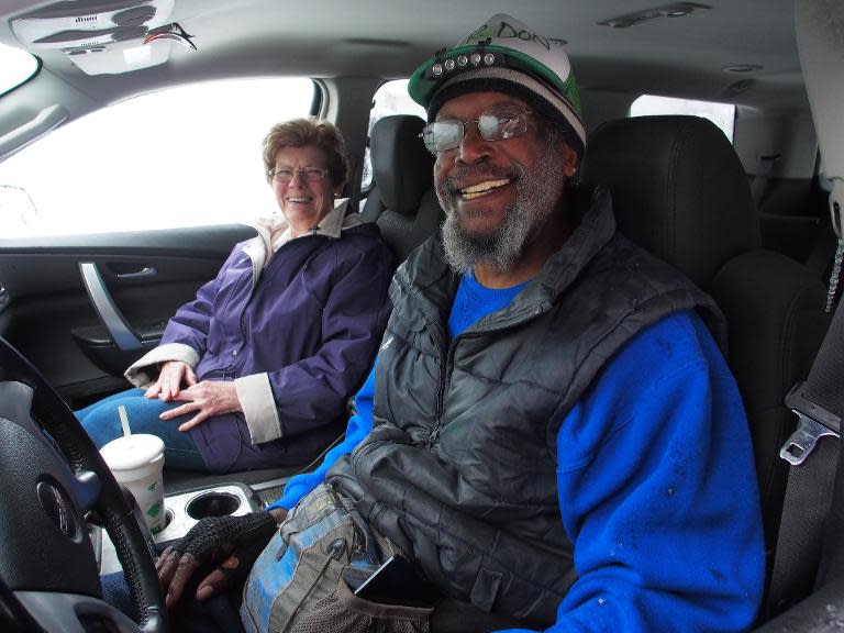 Don Robertson, 66, right, smiles as he prepares to give a lift to Mary Roberts, 88, amid a snowstorm on the first day of spring in Toms River, NJ on March 20, 2015