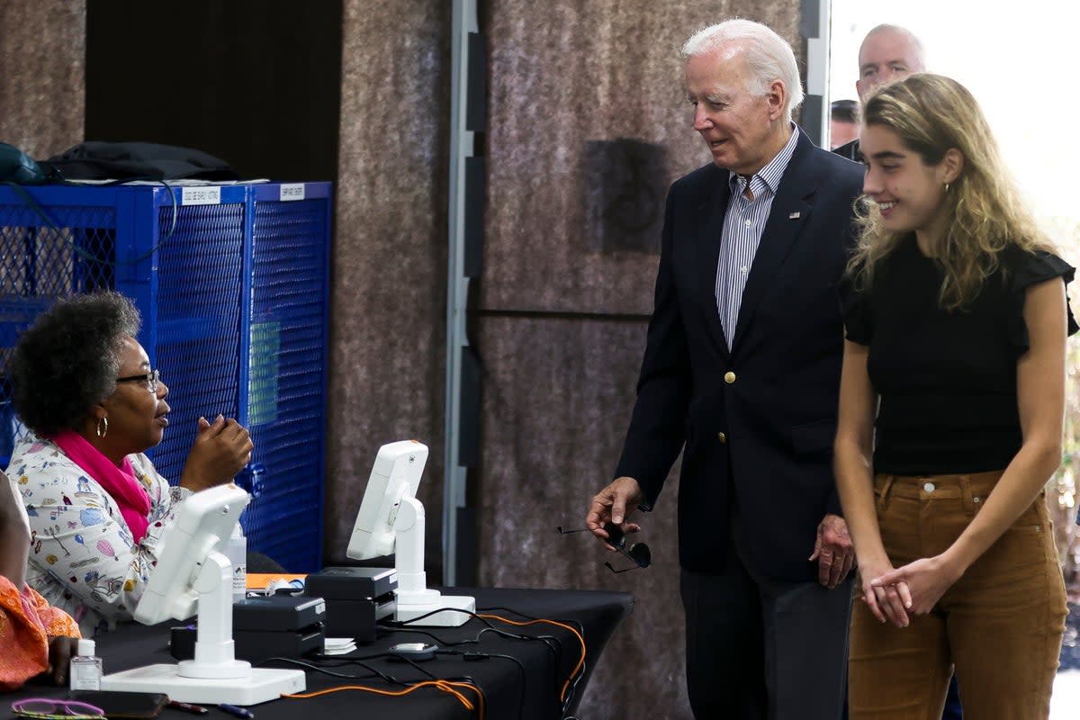 President Joe Biden arrives to cast his vote during early voting for the 2022 U.S. midterm elections with his granddaughter  (ASSOCIATED PRESS)