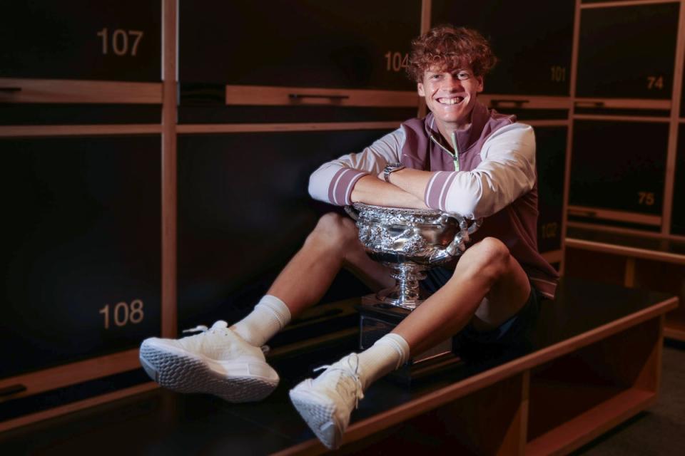 Jannik Sinner poses with the trophy in the locker room (AP)