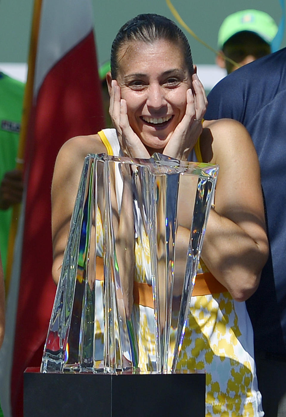 Flavia Pennetta, of Italy, reacts after being awarded the trophy after she beat Agnieszka Radwanska, of Poland, 6-2, 6-1, in the final round of the BNP Paribas Open tennis tournament, Sunday, March 16, 2014, in Indian Wells, Calif. (AP Photo/Mark J. Terrill)