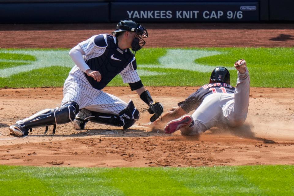 The Boston Red Sox's Rafael Devers slides past New York Yankees catcher Kyle Higashioka to score on a single by Masataka Yoshida during the sixth inning.