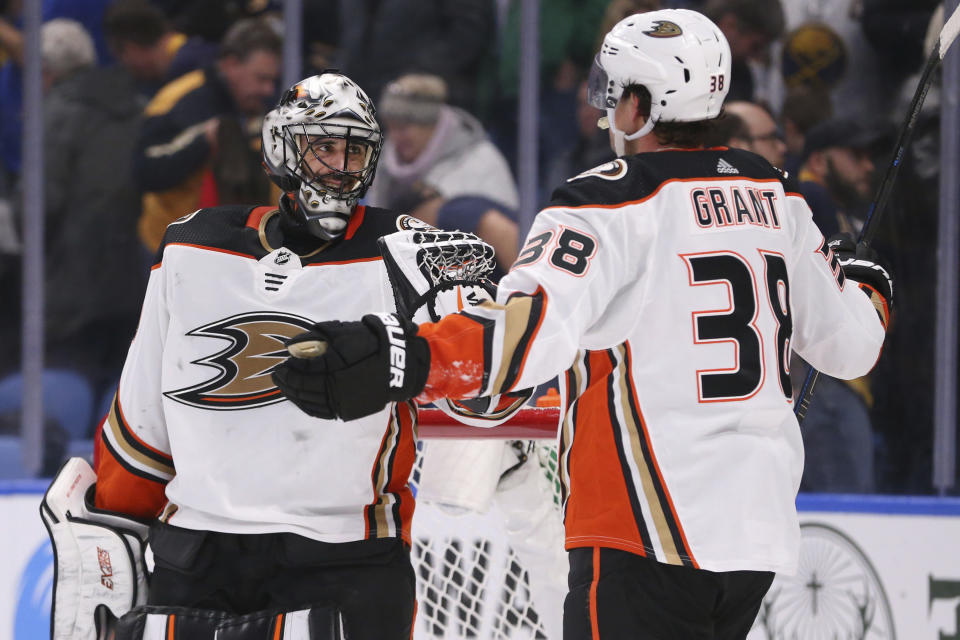 Anaheim Ducks goalie Ryan Miller (30) and forward Derek Grant (38) celebrate a 3-2 victory over the Buffalo Sabres following the third period of an NHL hockey game Sunday, Feb. 9, 2020, in Buffalo, N.Y. (AP Photo/Jeffrey T. Barnes)