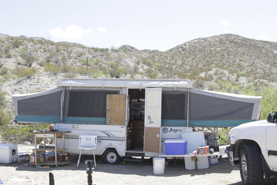 An trailer used by members of the United Constitutional Patriots sits a quarter mile from a barrier that marks the U.S.-Mexico border Tuesday, April 23, 2019, in Sunland Park, N.M., hours before its occupants were evicted by police. Members of the United Constitutional Patriots gained national attention after filming themselves detaining immigrants who cross the border to the east where the wall ends. (AP Photo/Cedar Attanasio)