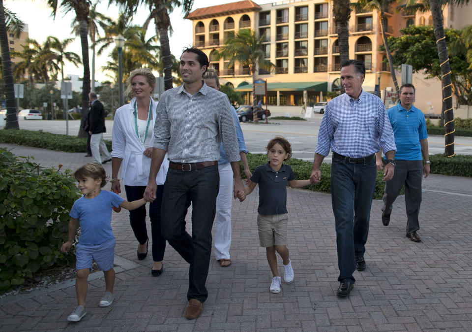 Republican presidential candidate, former Massachusetts Gov. Mitt Romney, second from right, walks with his family to dinner at BurgerFi on Sunday, Oct. 21, 2012 in Delray Beach, Fla. From left, grandson Miles, wife Ann, son Craig, daughter-in-law Mary, grandson Parker, and Romney. (AP Photo/ Evan Vucci)