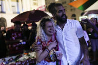 Followers of former Brazilian President Luiz Inacio "Lula" da Silva, who is running for president again, react as they listen to the partial results after general election polls closed in Rio de Janeiro, Brazil, Sunday, Oct. 2, 2022. (AP Photo/Silvia Izquierdo)