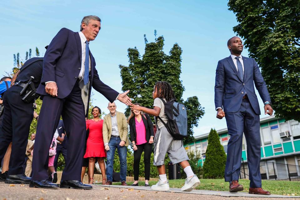 Governor John Carney (left) and former Delaware State Housing Authority Director Eugene Young (right) greeted students as they arrive for the first day school on Tuesday September 5, 2023 at EastSide Charter School in Wilmington. Carney has endorsed Young in the former housing cabinet secretary's pursuit for Delaware's U.S. Representative seat.