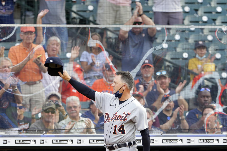 Detroit Tigers manager A.J. Hinch (14), the former Houston Astros manager, comes out of the dugout to acknowledge the crowd on his first visit back to Minute Maid Park before a baseball game against the Astros, Monday, April 12, 2021, in Houston. Hinch was fired by the Astros in 2019 for his part in the Astros cheating scandal. (AP Photo/Michael Wyke)