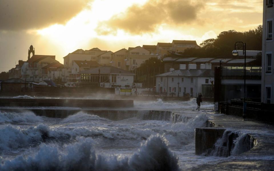 Waves crash against the sea wall in Swanage, Dorset earlier this month. Walls built to protect seaside developments prevent a beach from migrating inland  - Steve Parsons /PA