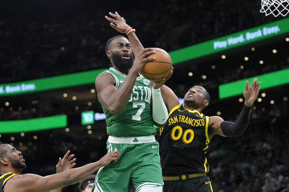 Boston Celtics guard Jaylen Brown (7) drives to the basket as Golden State Warriors forward Jonathan Kuminga (00) defends in the second half of an NBA basketball game, Sunday, March. 3, 2024, in Boston. (AP Photo/Steven Senne)