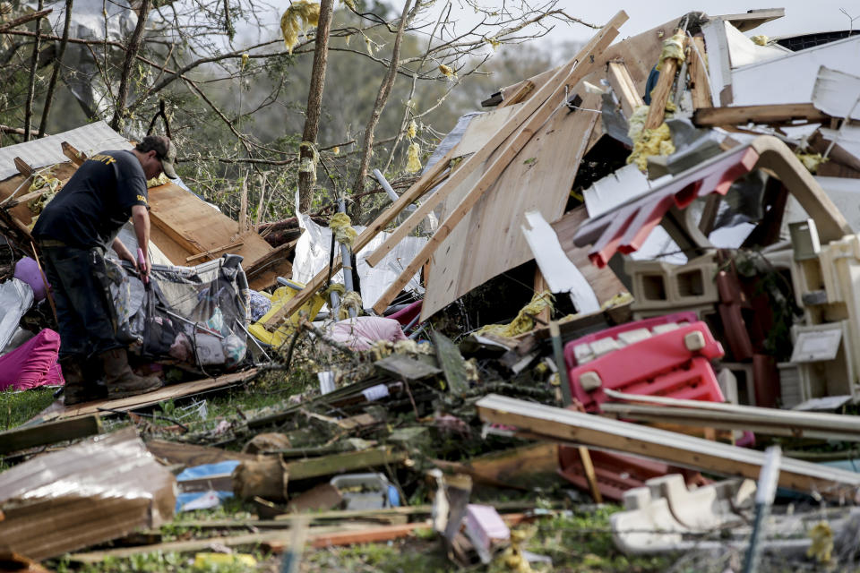 Residents begin the clean up process after a tornado touched down Friday, March 26, 2021 in Wellington, Ala. A tornado outbreak has ripped across the Deep South leaving paths of destruction. (AP Photo/Butch Dill)