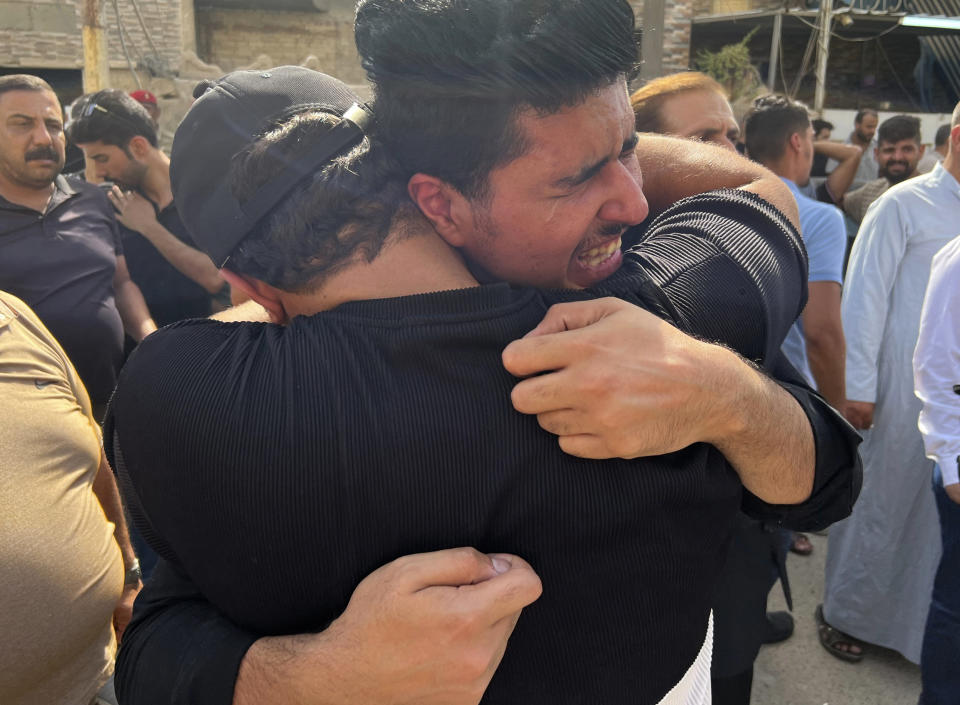 Men mourn Abbas Abdul Hussein, a 30-year-old victim of an artillery strike, after his body was received by his family in Baghdad, to later lay him to rest in Najaf city, Thursday, July 21, 2022, in Baghdad, Iraq. Hussein was on his honeymoon, five days after his wedding, when at least four artillery shells struck the resort area of Barakh in the Zakho district in the Iraqi semi-autonomous Kurdish-run region, killing nine people. (AP Photo/Ali Jabar)