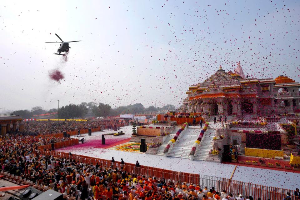 An Indian Air Force helicopter showers flower petals during the opening of Ram temple (AP)