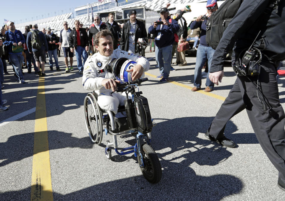 Alex Zanardi makes his way back to his garage after driving during a practice session for the IMSA 24 hour race at Daytona International Speedway, Friday, Jan. 25, 2019, in Daytona Beach, Fla. (AP Photo/John Raoux)