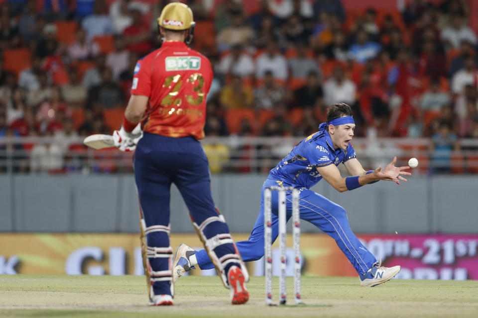 Mumbai Indians' Gerald Coetzee takes the catch to dismiss Punjab Kings' Liam Livingstone during the Indian Premier League cricket match between Punjab Kings' and Mumbai Indians' in Mullanpur ,India, Thursday, April 18, 2024.(AP Photo/ Surjeet Yadav))