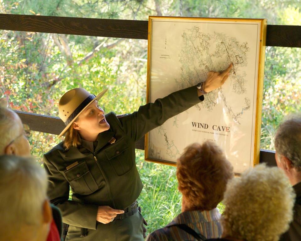 A park ranger points to a map of Wind Cave.