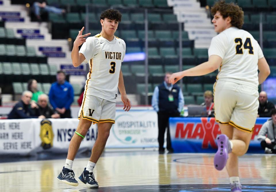 Victor's AJ Queri, left, reacts after scoring against Brentwood during a NYSPHSAA Class AA Boys Basketball Championship semifinal in Glens Falls, N.Y., Friday, March 17, 2023. Victor advanced to the Class AA title game with a 56-41 win over Brentwood-XI.