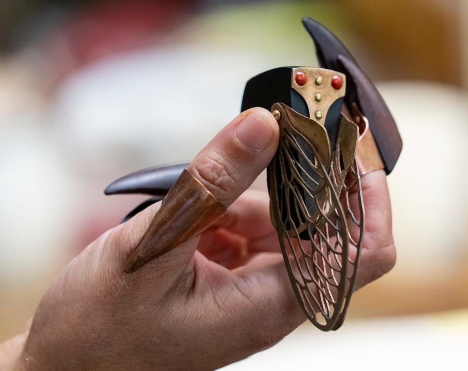 A cicada, made with wood and metal, by jewelry artist Allison Ford at The Harrison Center in downtown Indianapolis, Monday, July 11, 2022, which serves as a studio space and collaboration spot for area artists. 