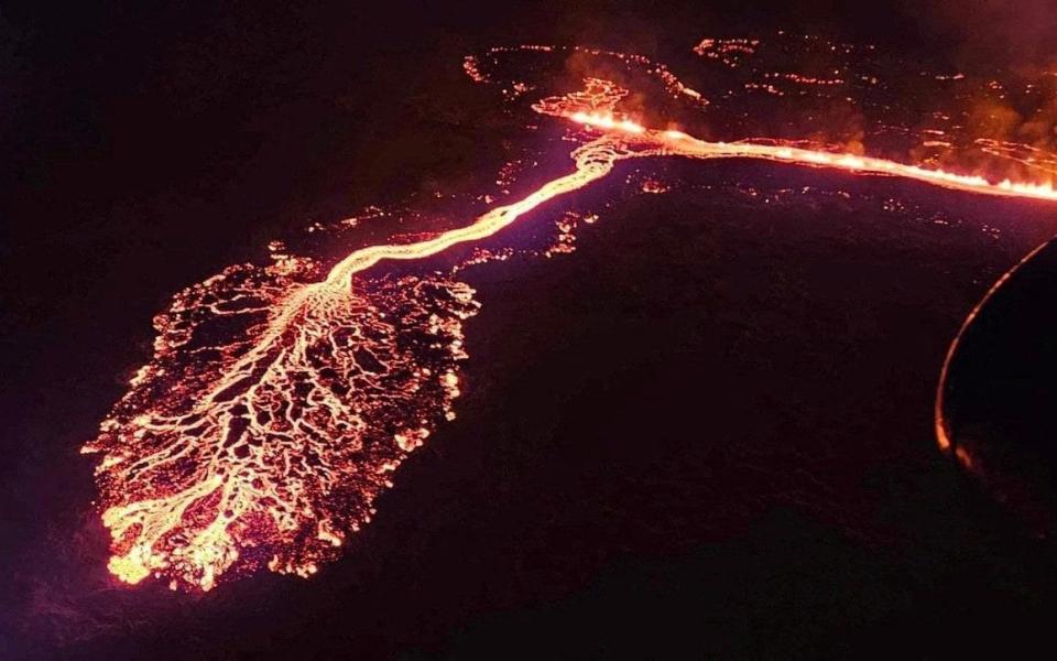 A volcano spews lava and smoke as it erupts near Grindavik