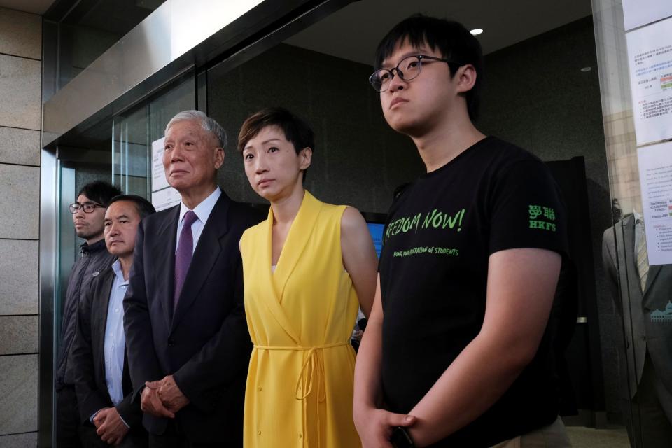 Pro-democracy activists Chung Yiu-wa, Lee Wing-tat, Chu Yiu-ming, Tanya Chan and Cheung Sau-yin leave the court on Wednesday (Tyrone Siu/Reuters)