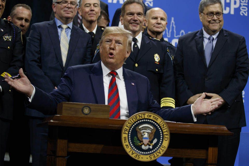 President Donald Trump signs an executive order during the International Association of Chiefs of Police Annual Conference and Exposition, at the McCormick Place Convention Center Chicago, Monday, Oct. 28, 2019, in Chicago. (AP Photo/Evan Vucci)