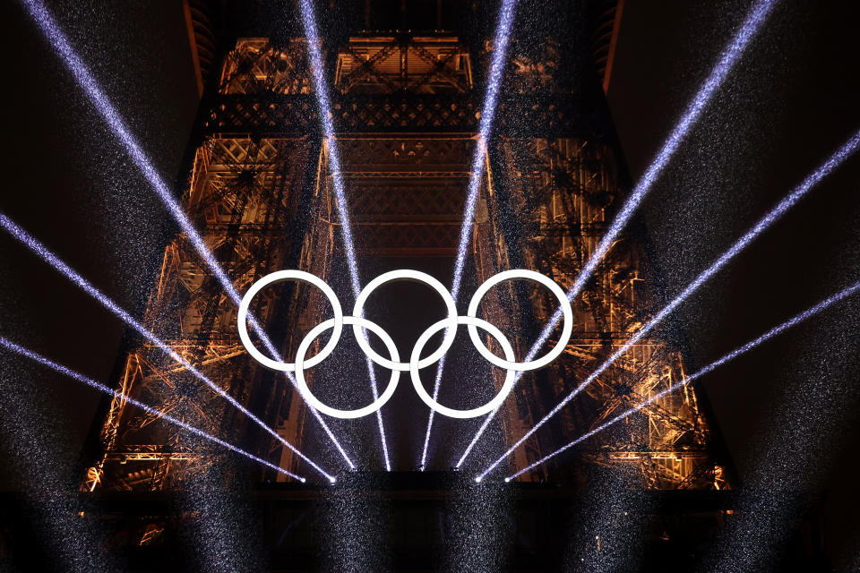 PARIS, FRANCE - JULY 26: A Light Show takes place as The Olympic Rings on the Eiffel Tower are illuminated during the opening ceremony of the Olympic Games Paris 2024 at Place du Trocadero on July 26, 2024 in Paris, France. (Photo by Ryan Pierse/Getty Images)