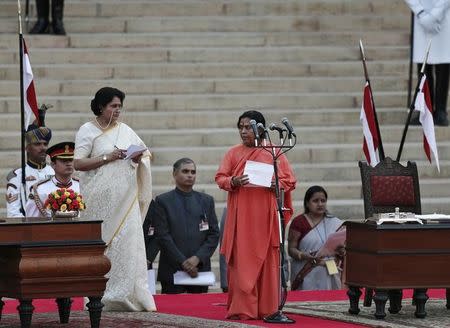 Uma Bharti (2nd R) is administered oath of office by India's President Pranab Mukherjee (unseen) as a cabinet minister at Rashtrapati Bhavan in New Delhi May 26, 2014. REUTERS/Adnan Abidi/Files